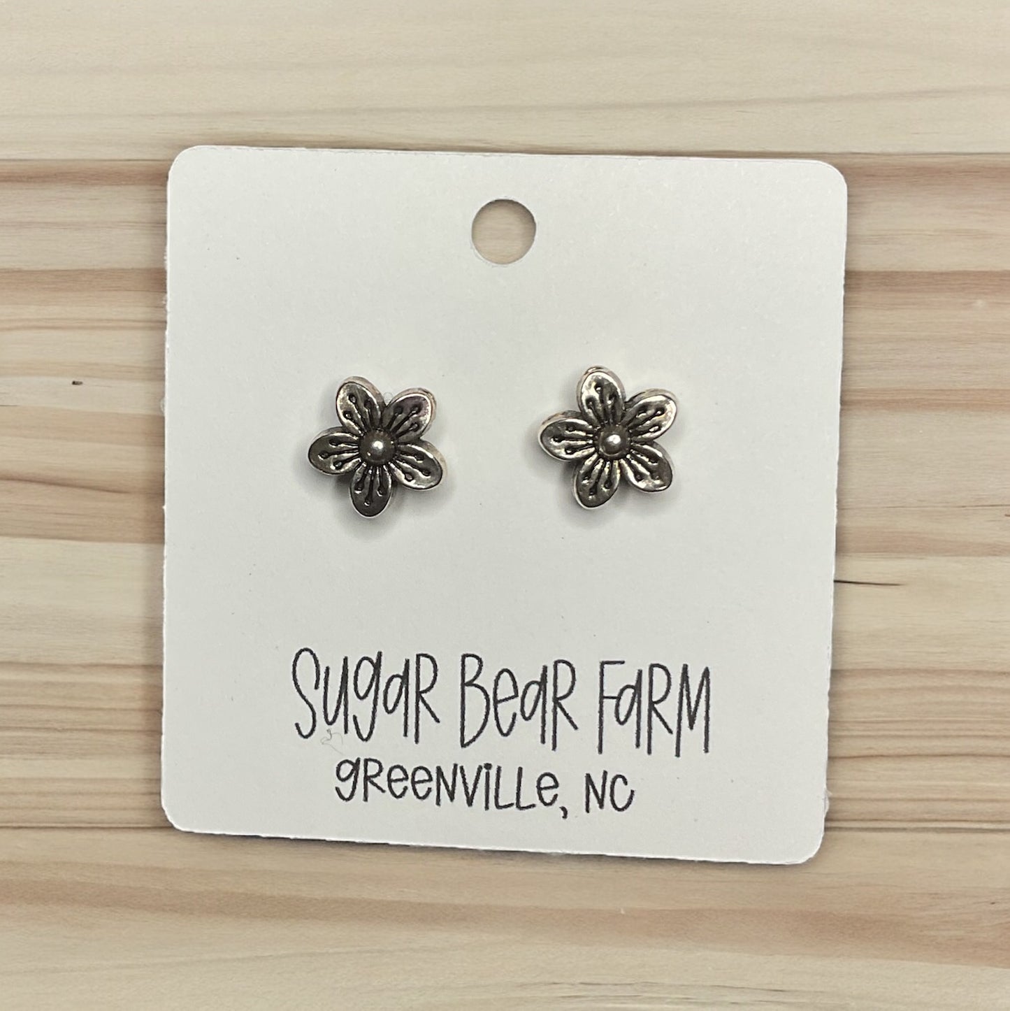 silver colored flower stud earrings