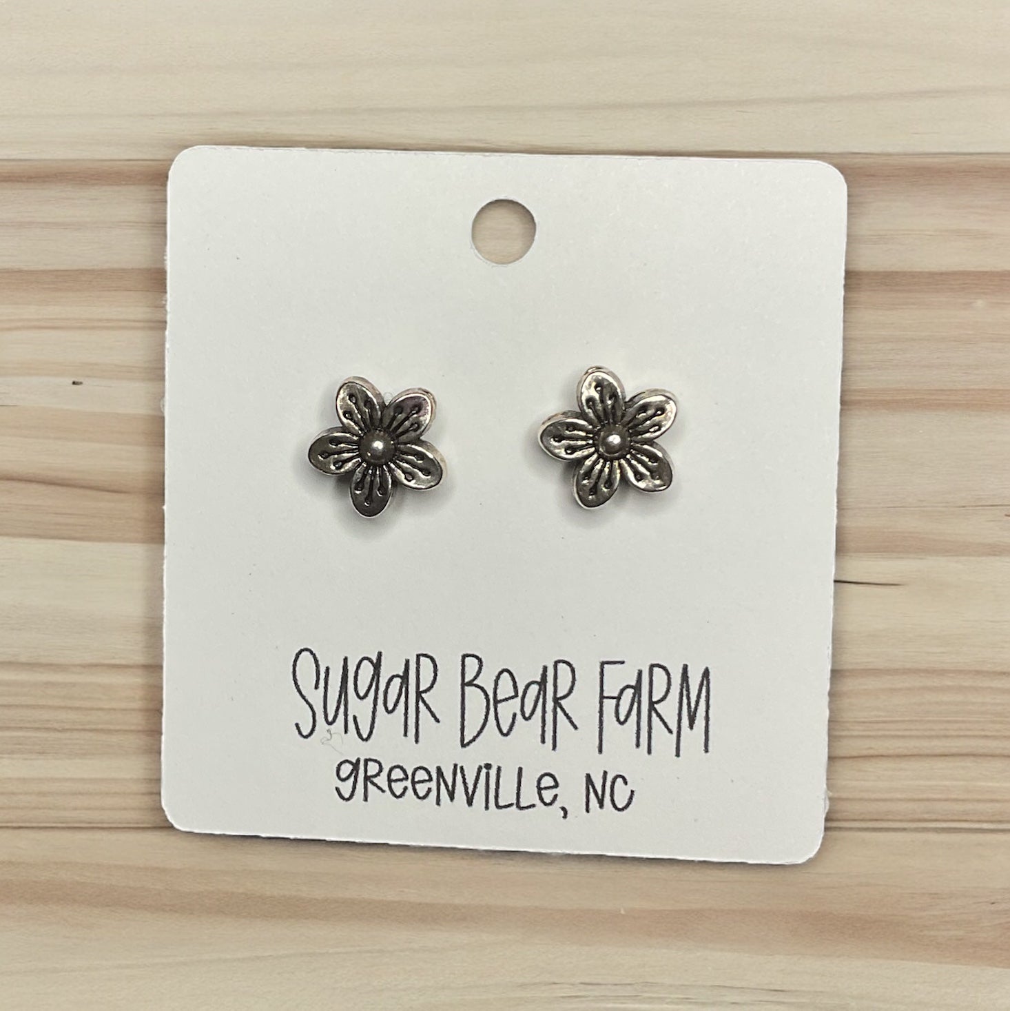 silver colored flower stud earrings