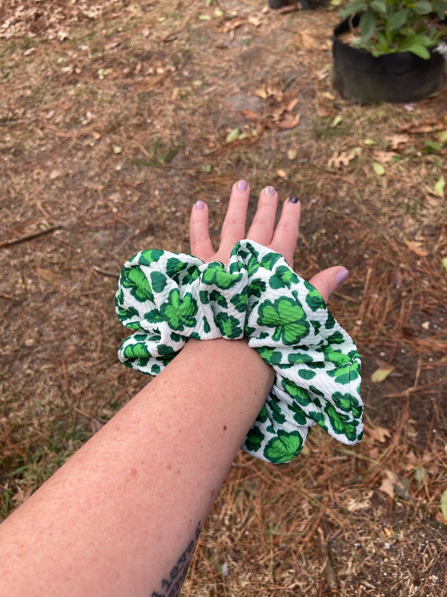 green and white shamrock scrunchie on arm