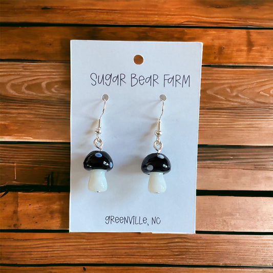 pair of black and white glass mushroom earrings