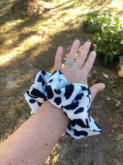  cow themed scrunchie on wrist