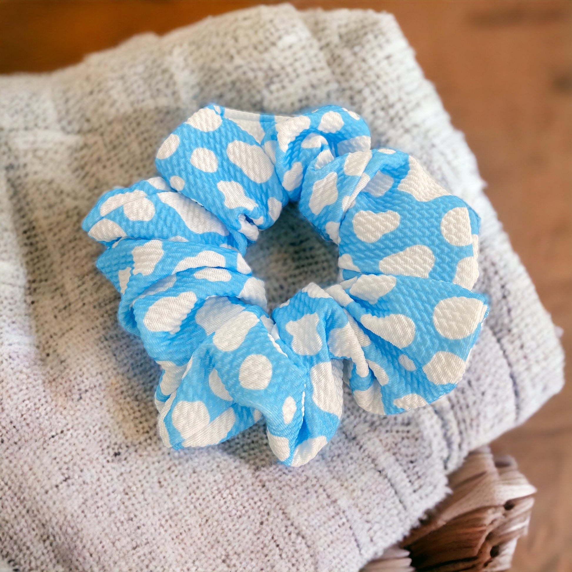 blue cow themed scrunchie on blanket