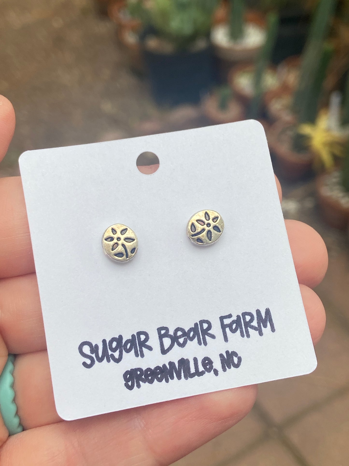 silver colored flower stud earrings