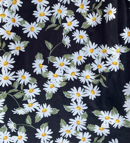 black fabric with white and yellow flowers