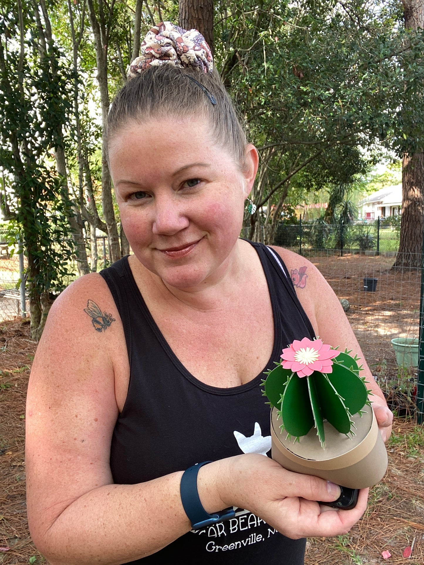 woman holding a paper cactus with paper flower