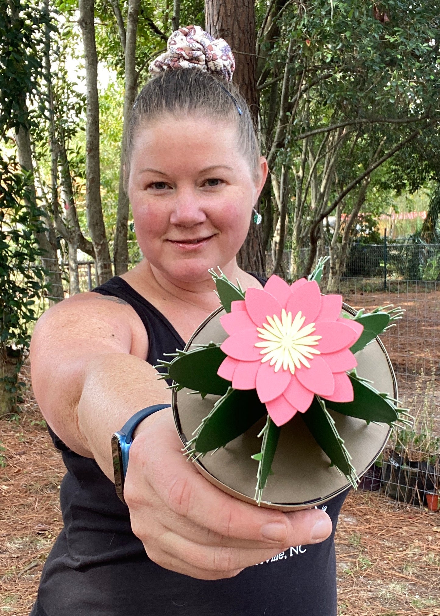 woman holding a paper cactus with paper flower