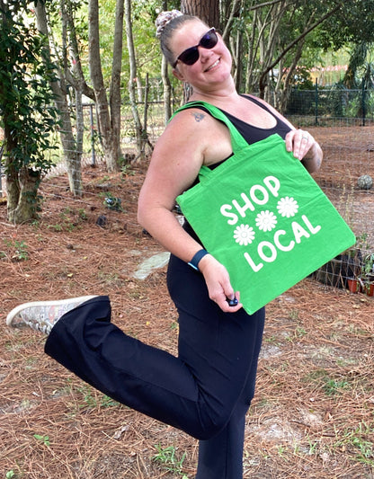 woman with green and white shop local tote bag