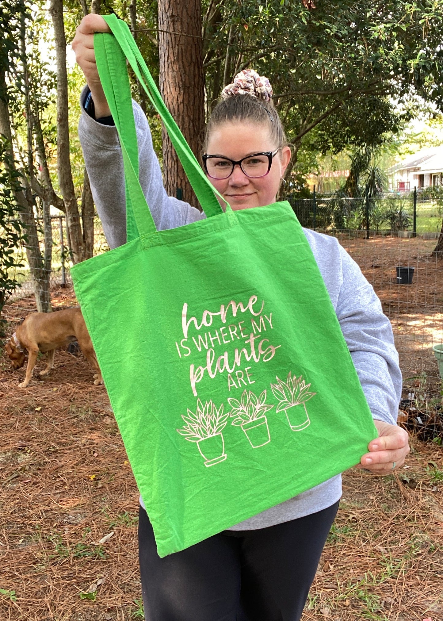 Green totebag that reads home is where my plants are