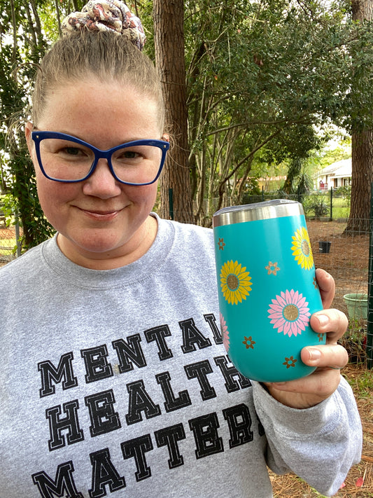 Woman holding a blue flower tumbler