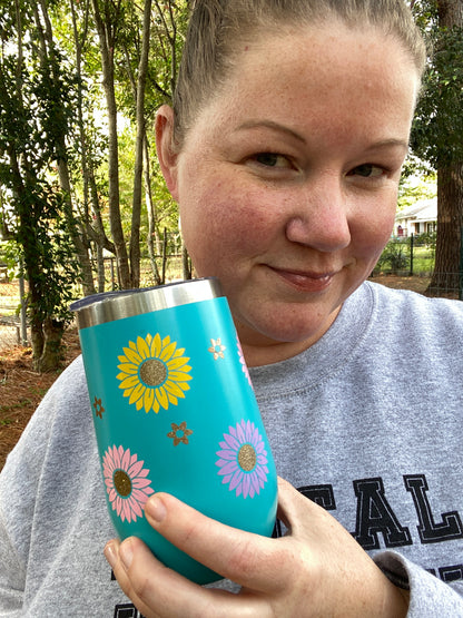 girl holding blue flower tumbler