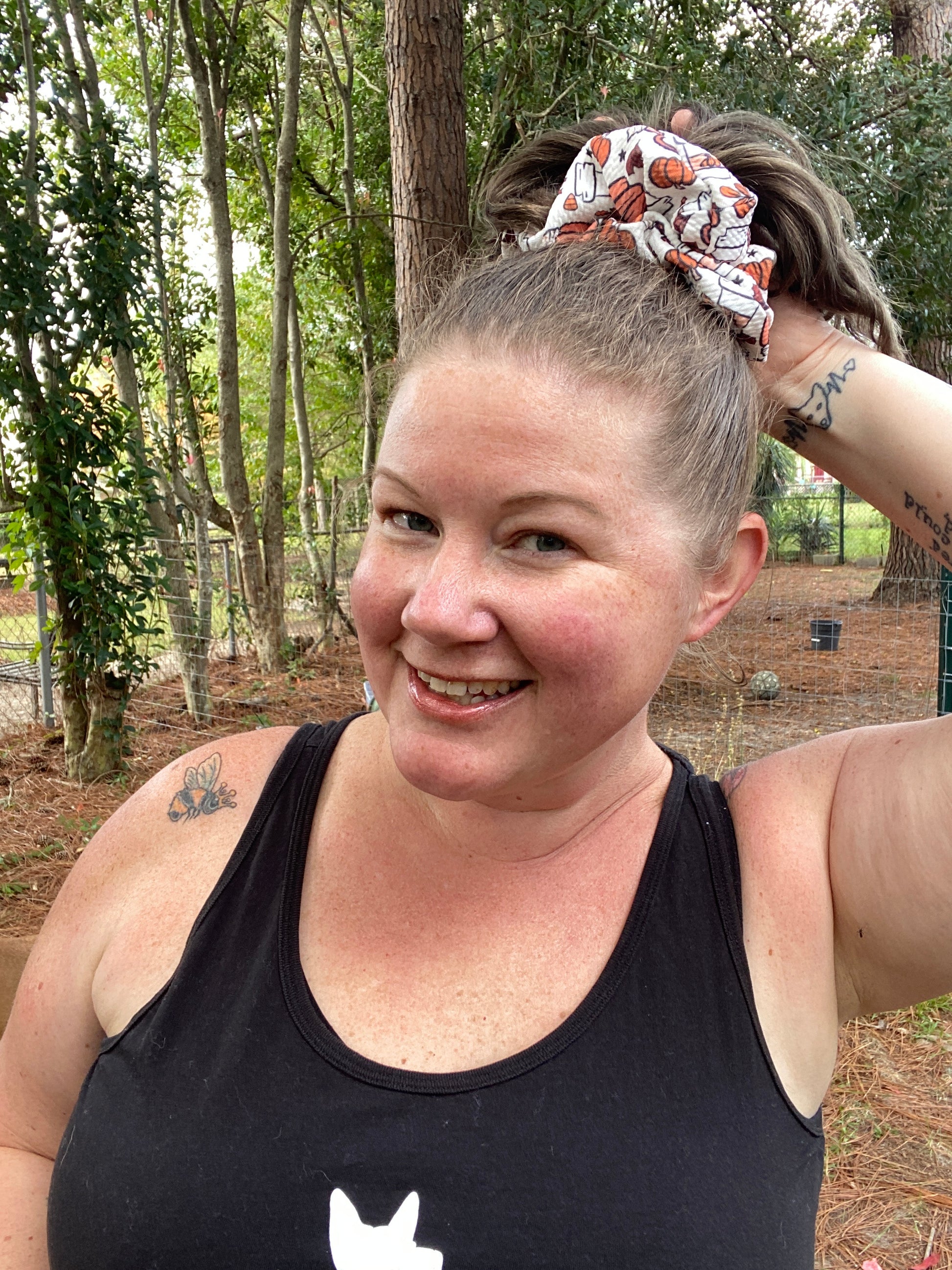 woman wearing white and orange pumpkin scrunchie