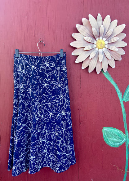 blue and white skirt and daisy flower on red background