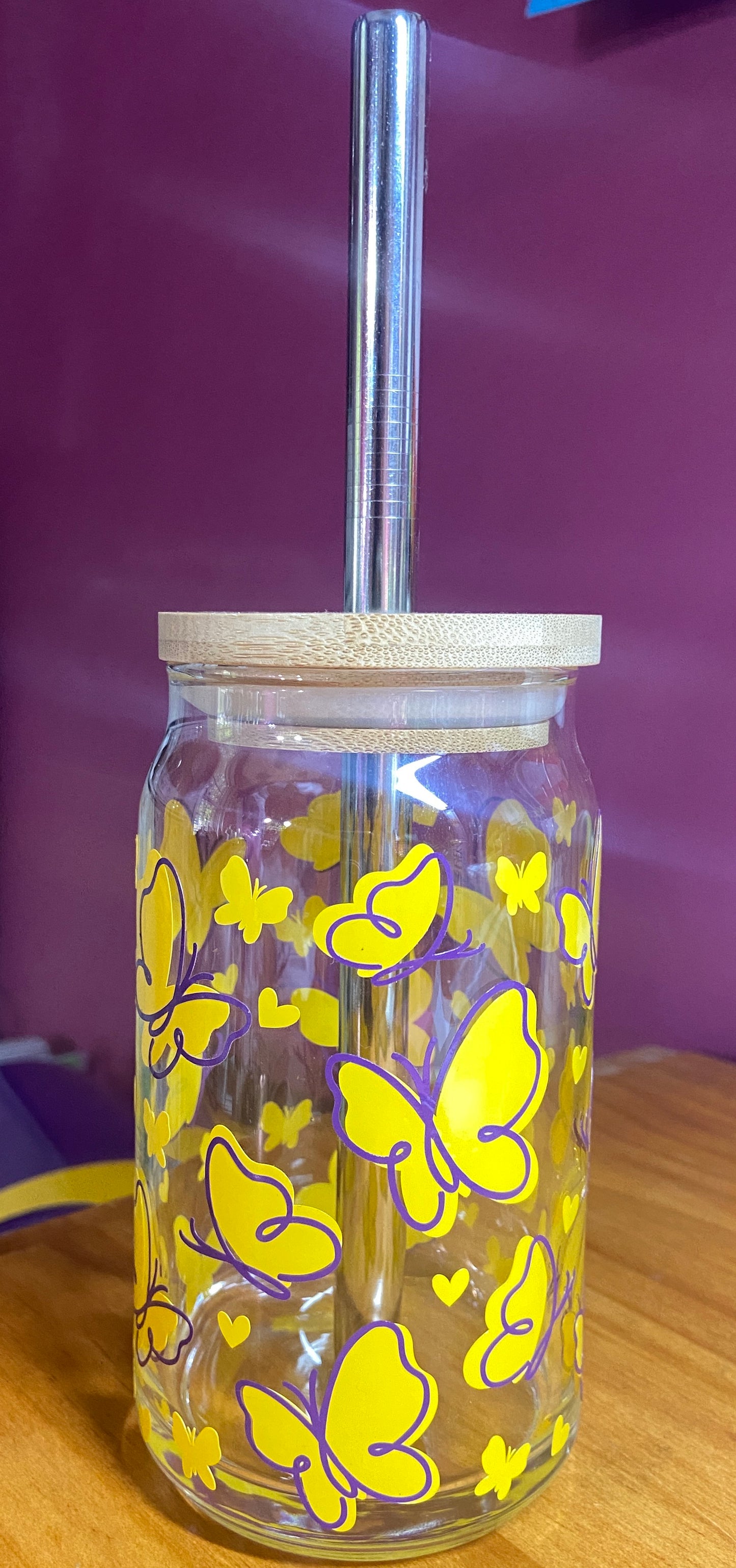 Beer glass with yellow and purple butterflies