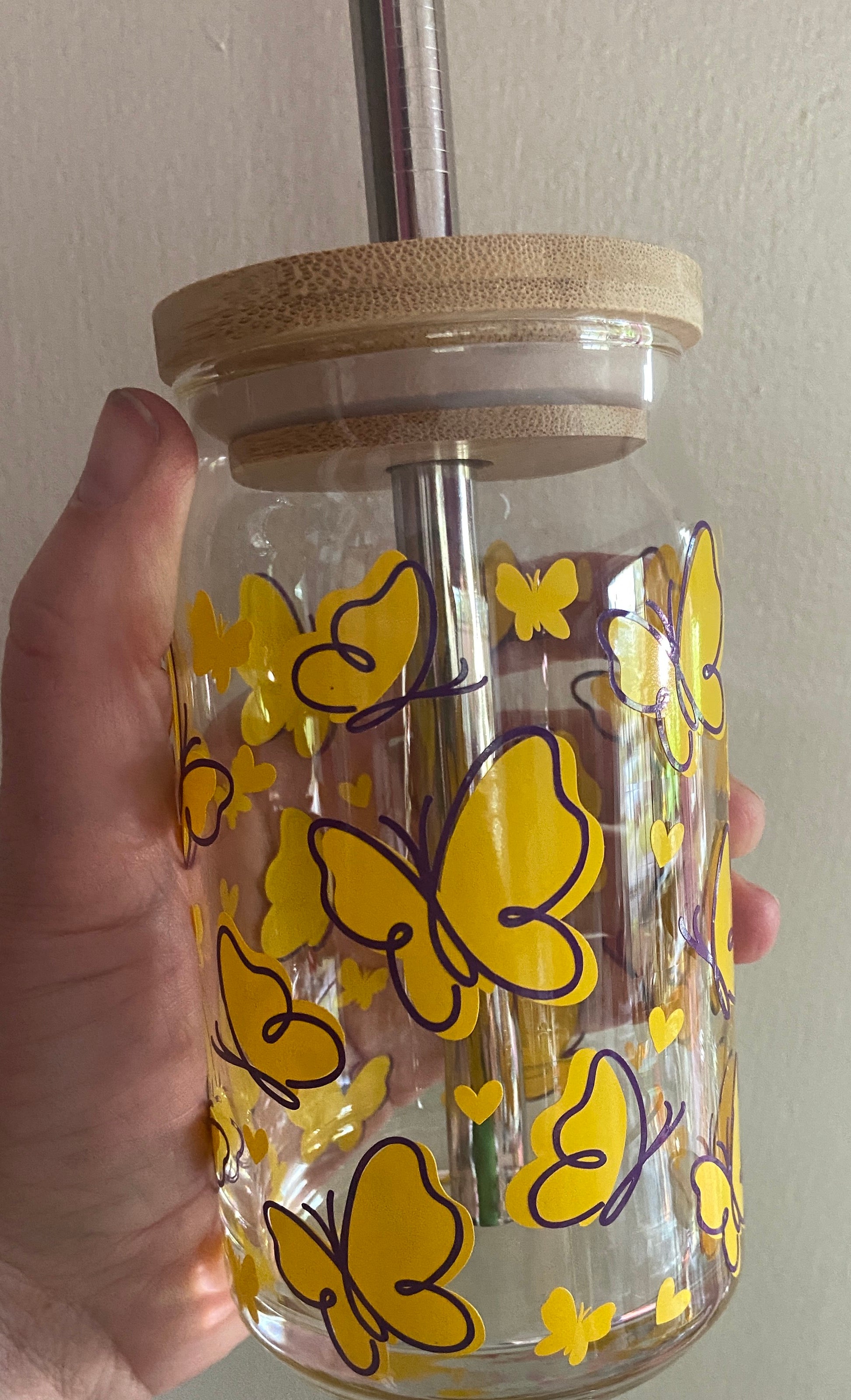 Beer glass with yellow and purple butterflies