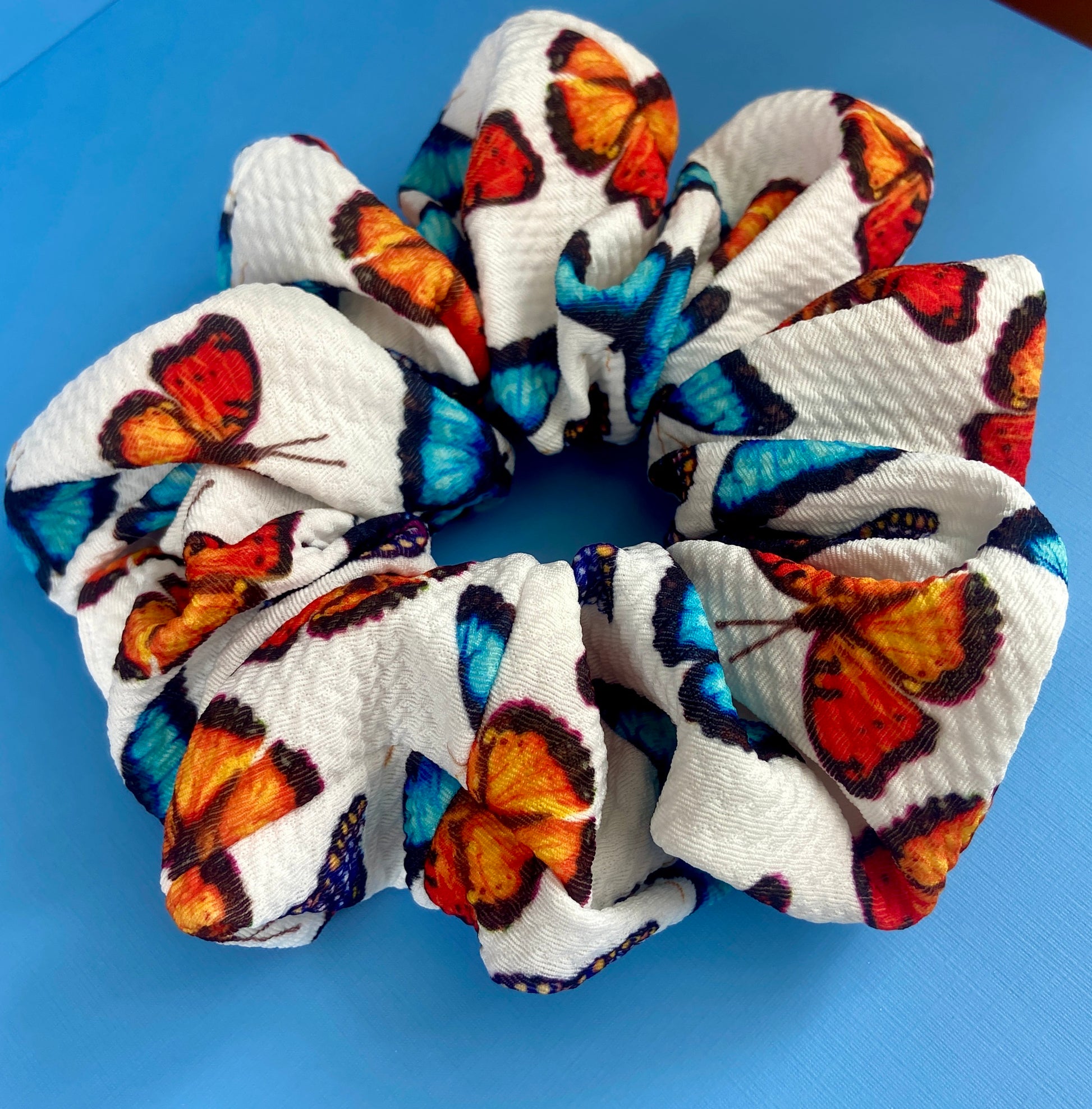 butterfly scrunchie on blue background