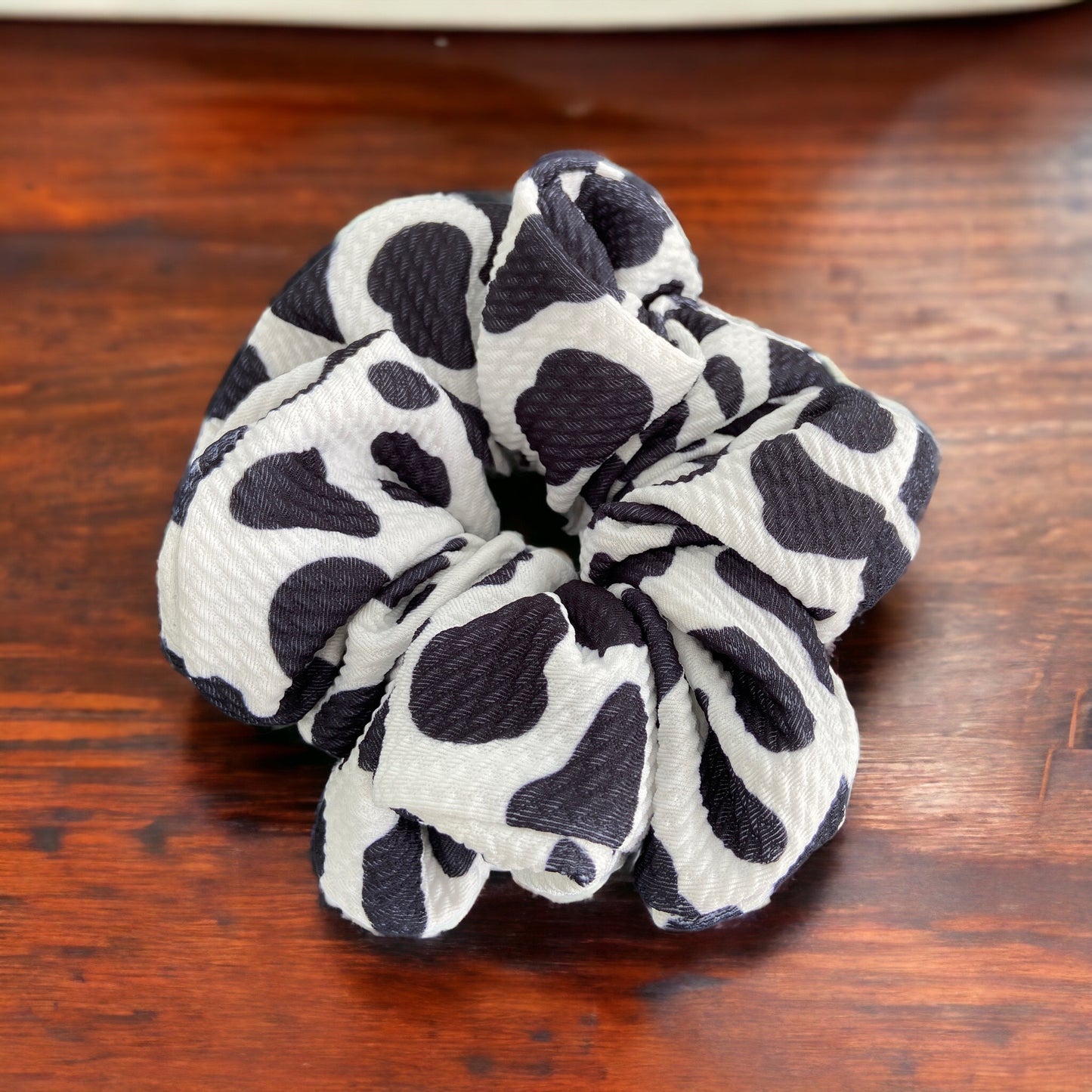 cow scrunchie on wood