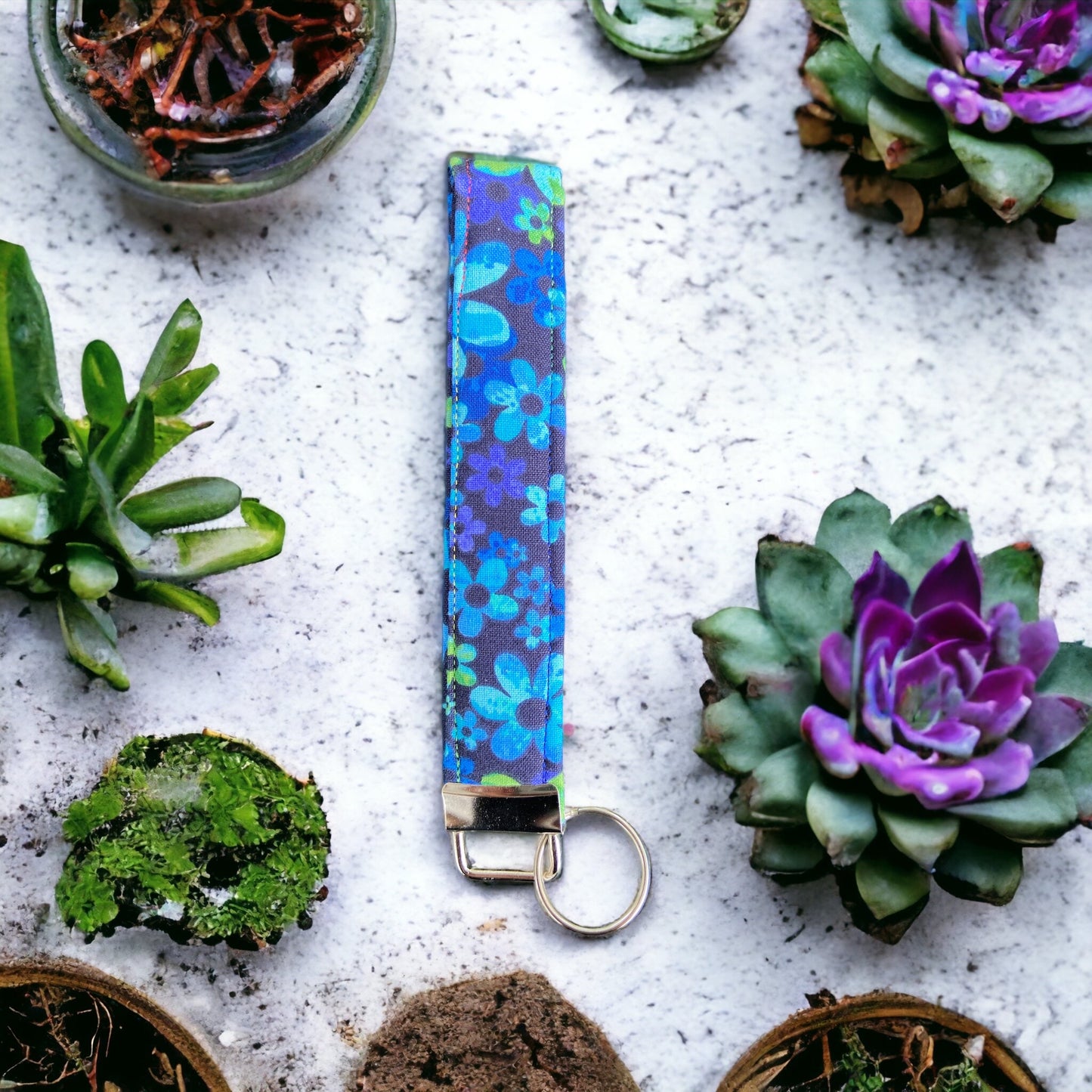 blue flower keychain and succulents