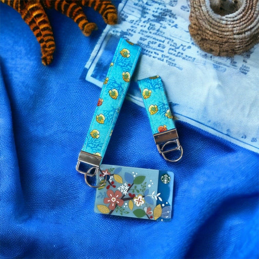 blue wristlet with yellow and orange fish and gift card