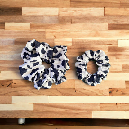 two cow scrunchies on wood