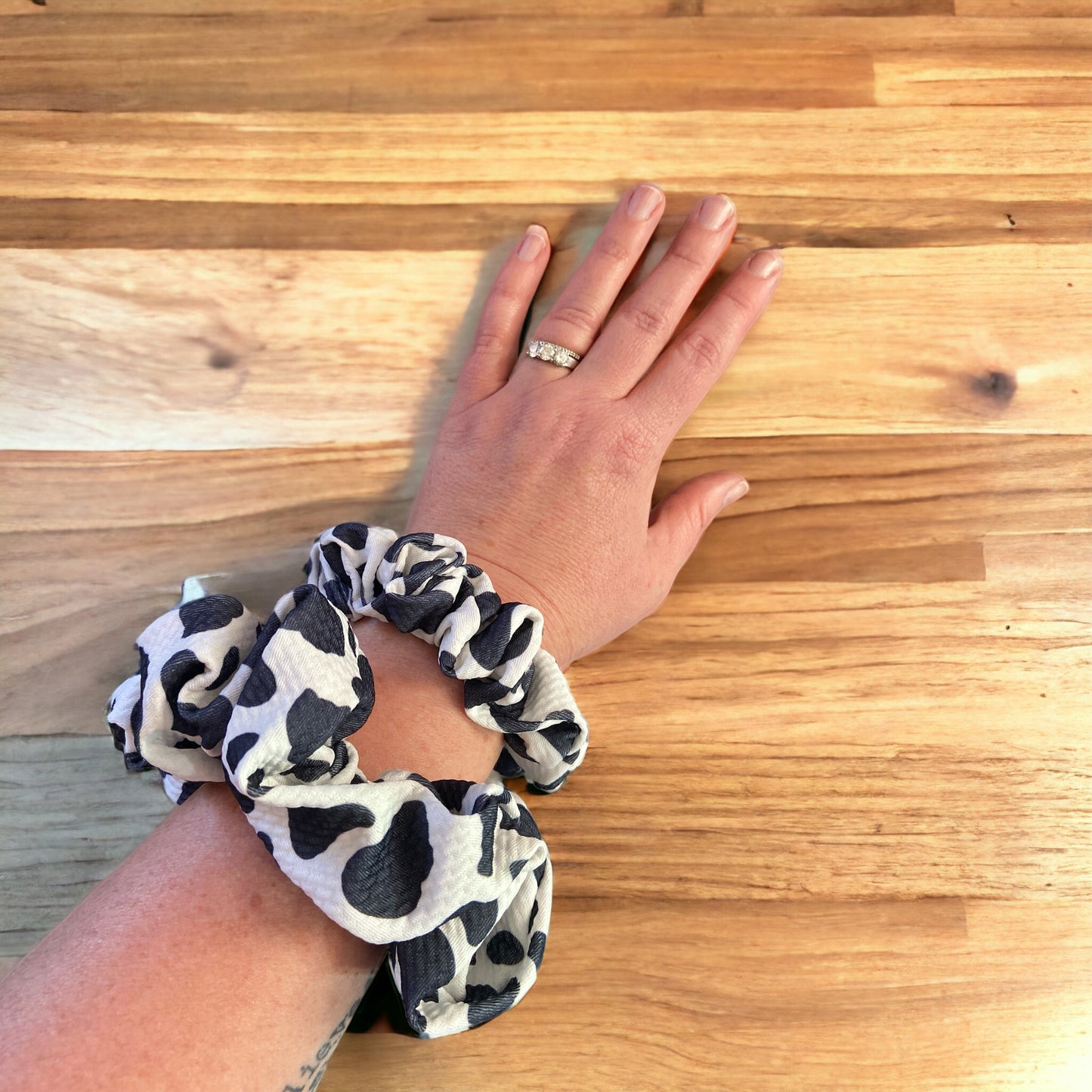 two cow scrunchies on arm