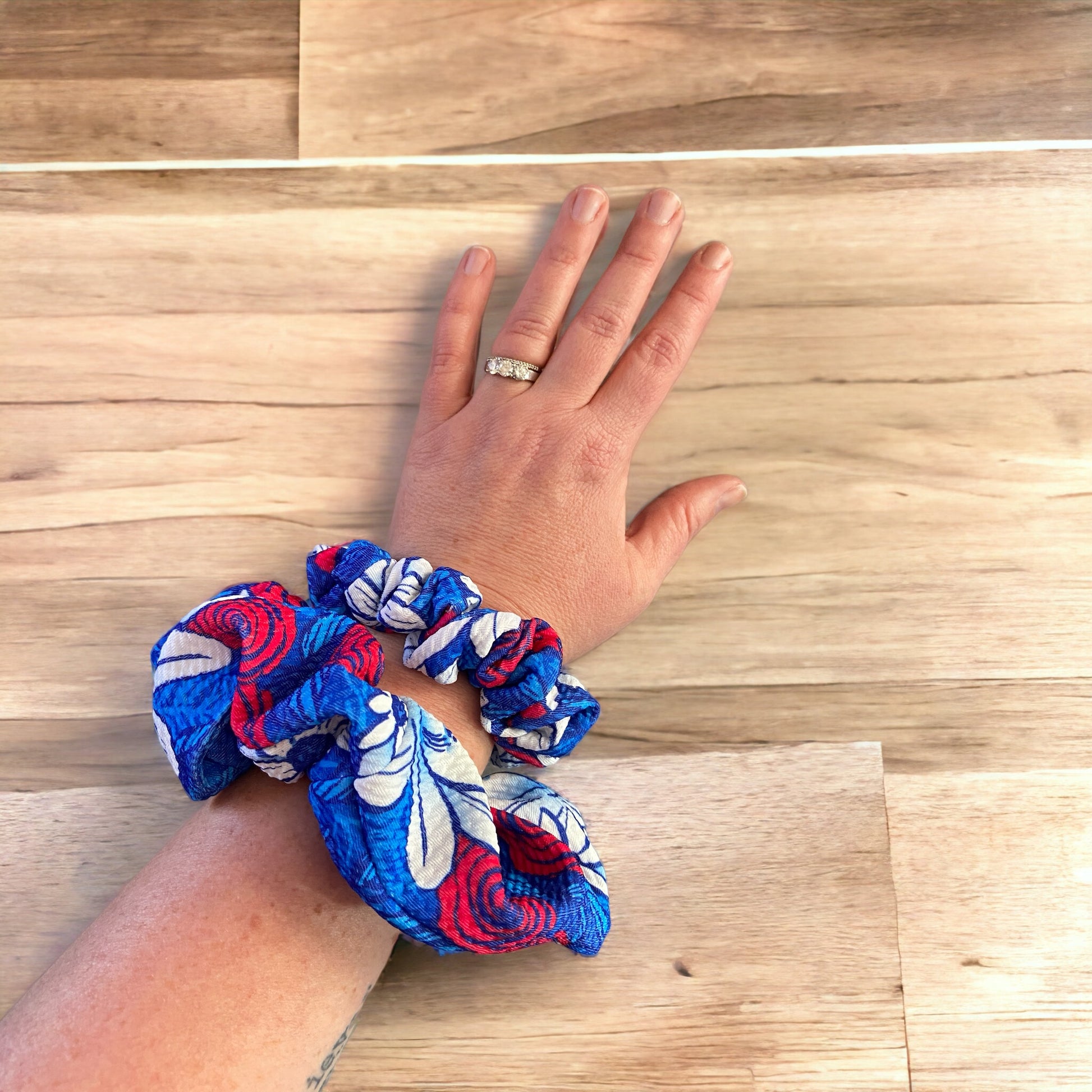 red, white, and blue floral scrunchies on wrist