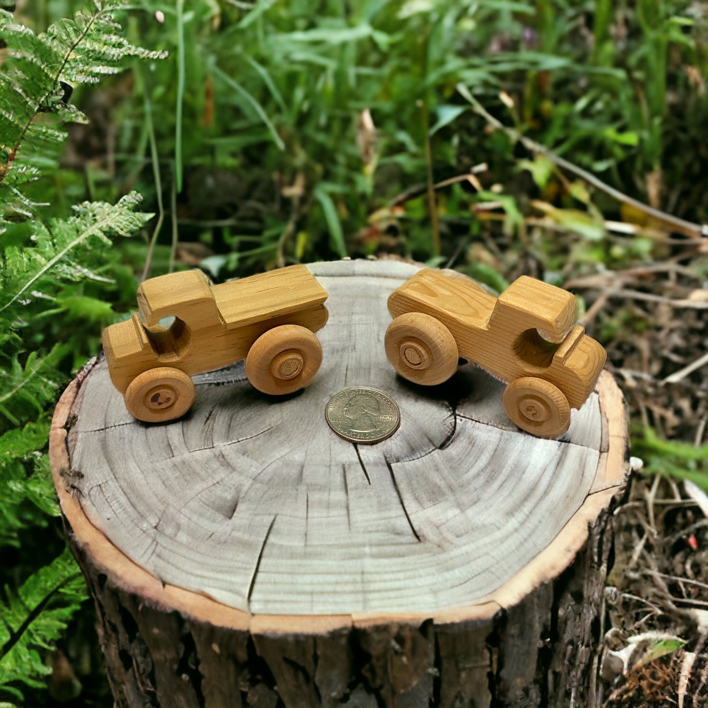 two wooden pickup trucks on a stump