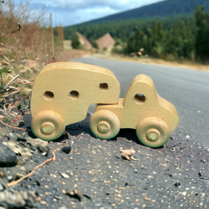 small wooden truck with camper on street