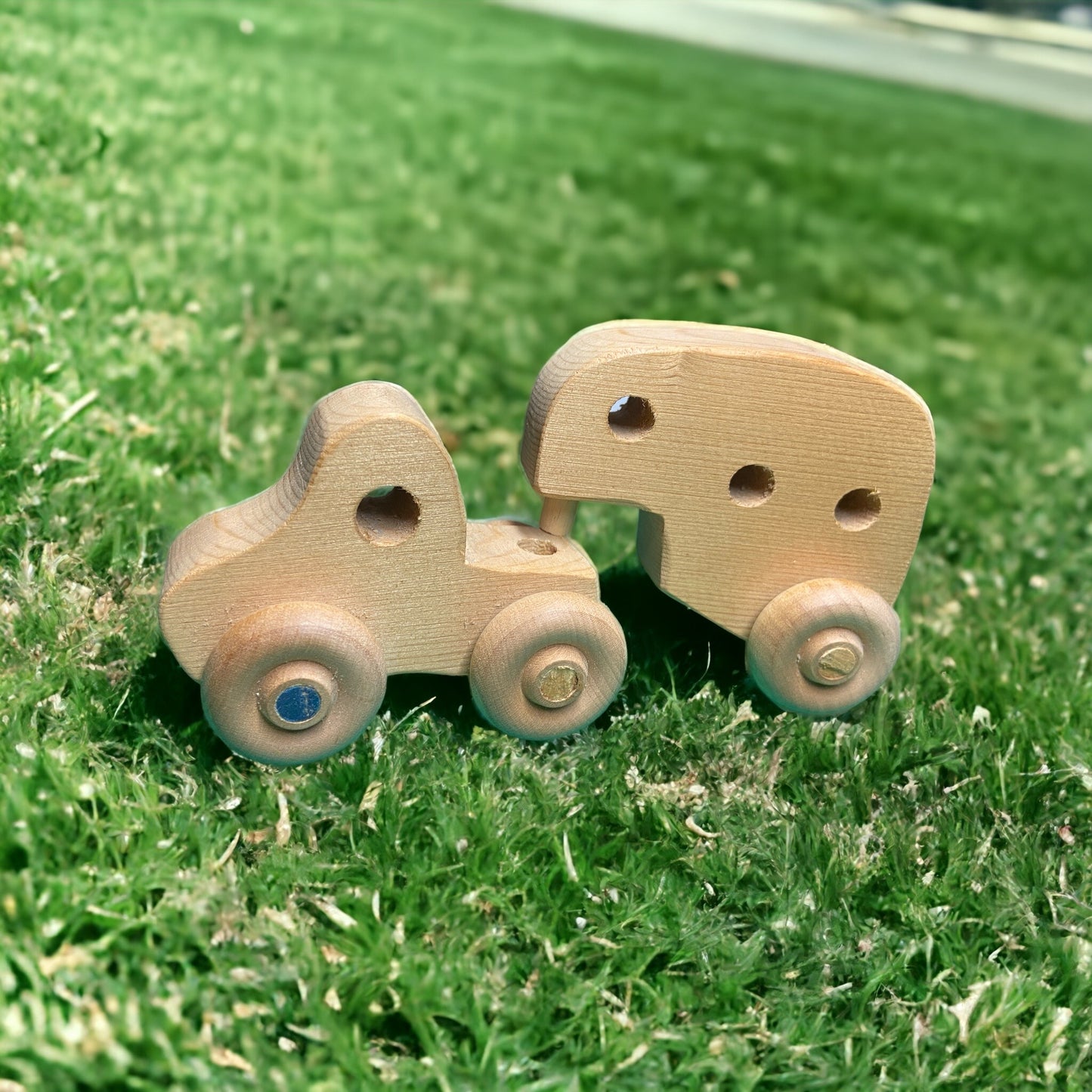 small wooden truck with camper on grass