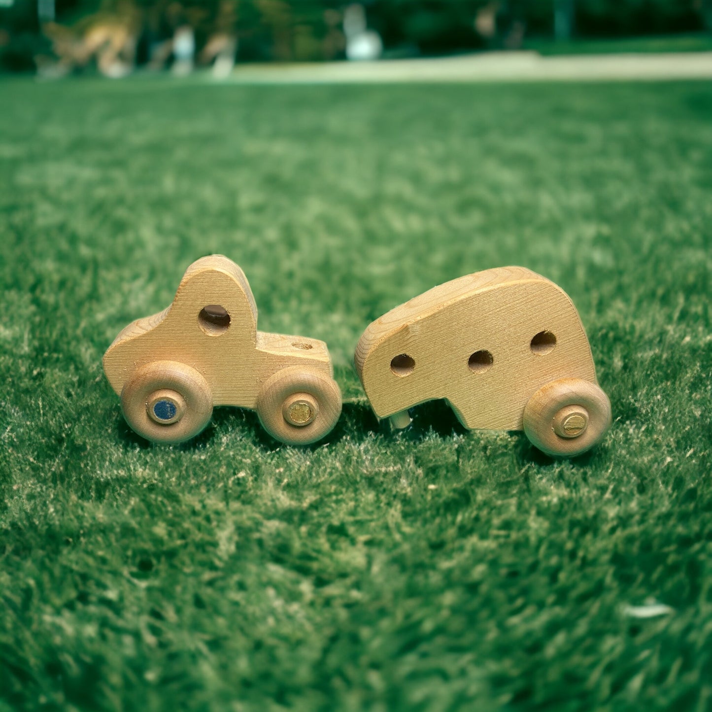 small wooden truck with camper on grass