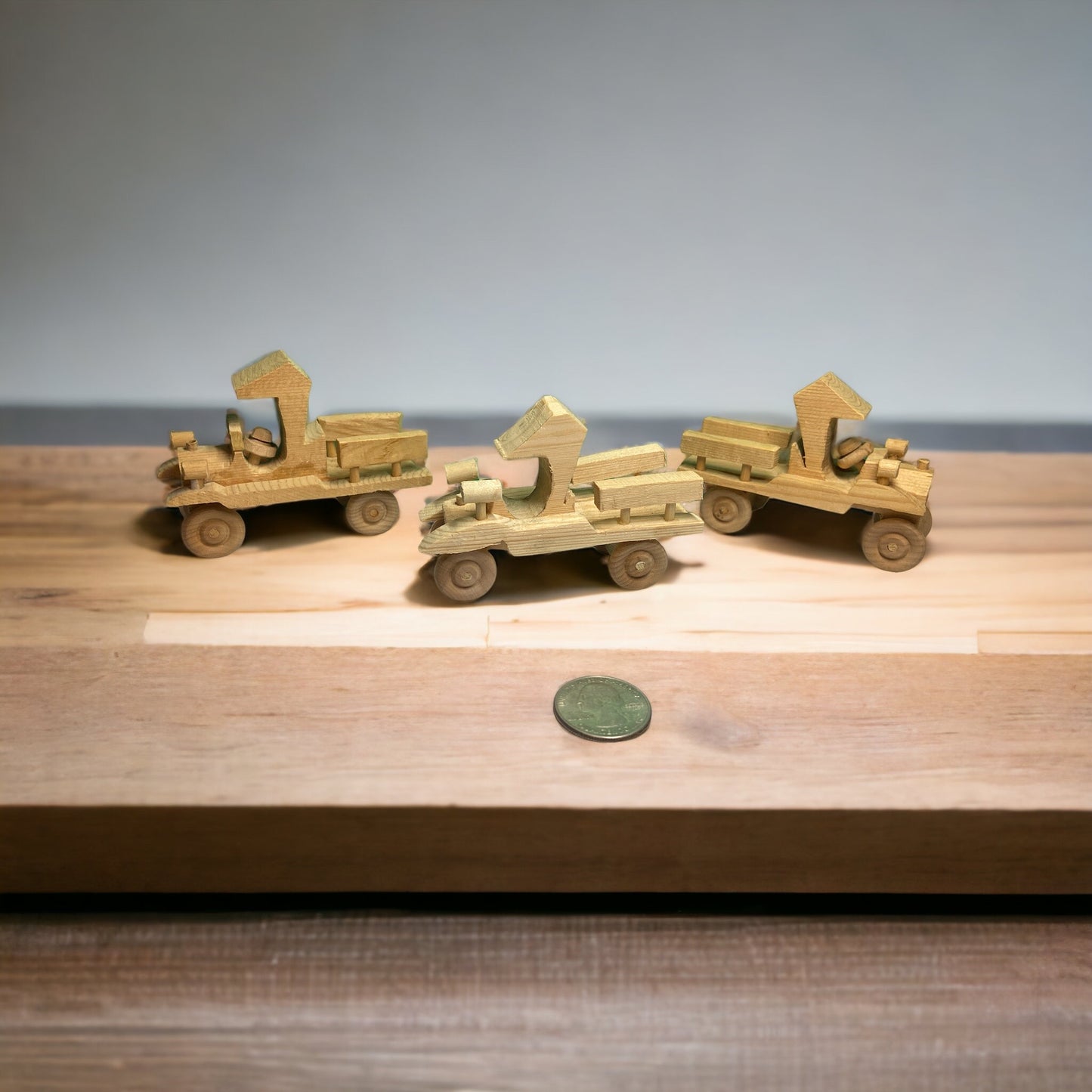 three wooden trucks