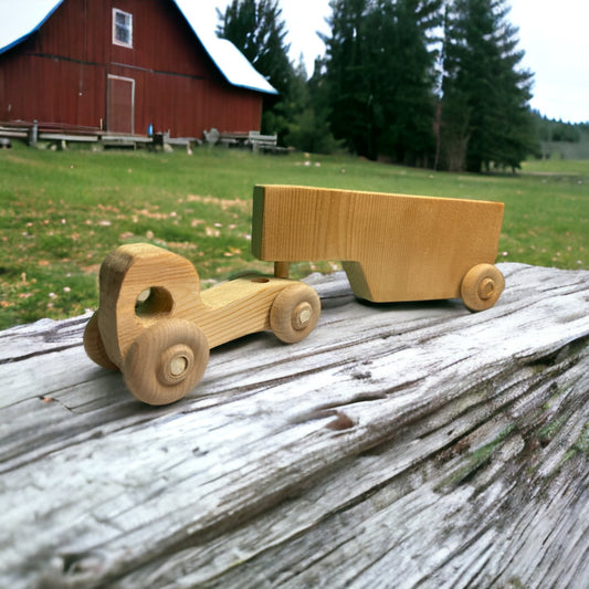 Wooden truck and trailer on a log