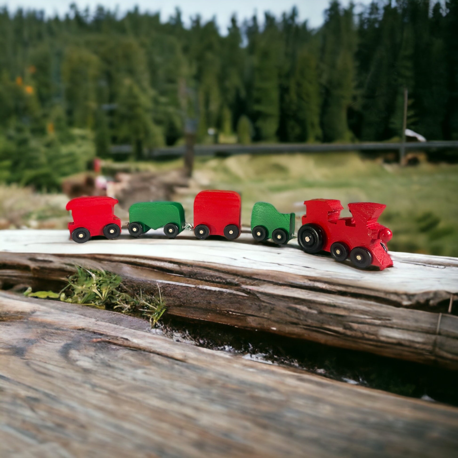 red and green wooden train on a log