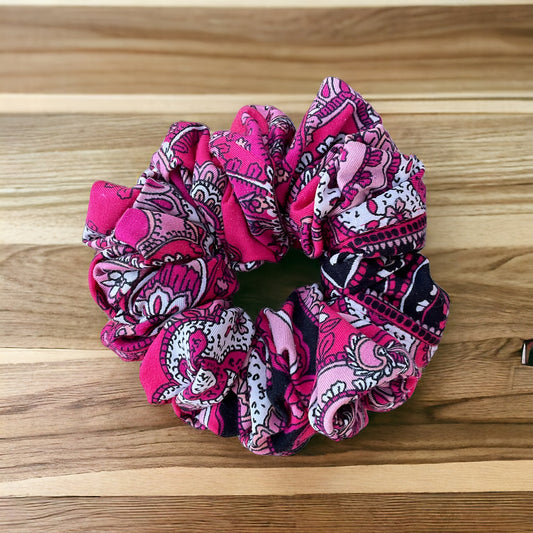 bright pink and white and black scrunchie on wooden background