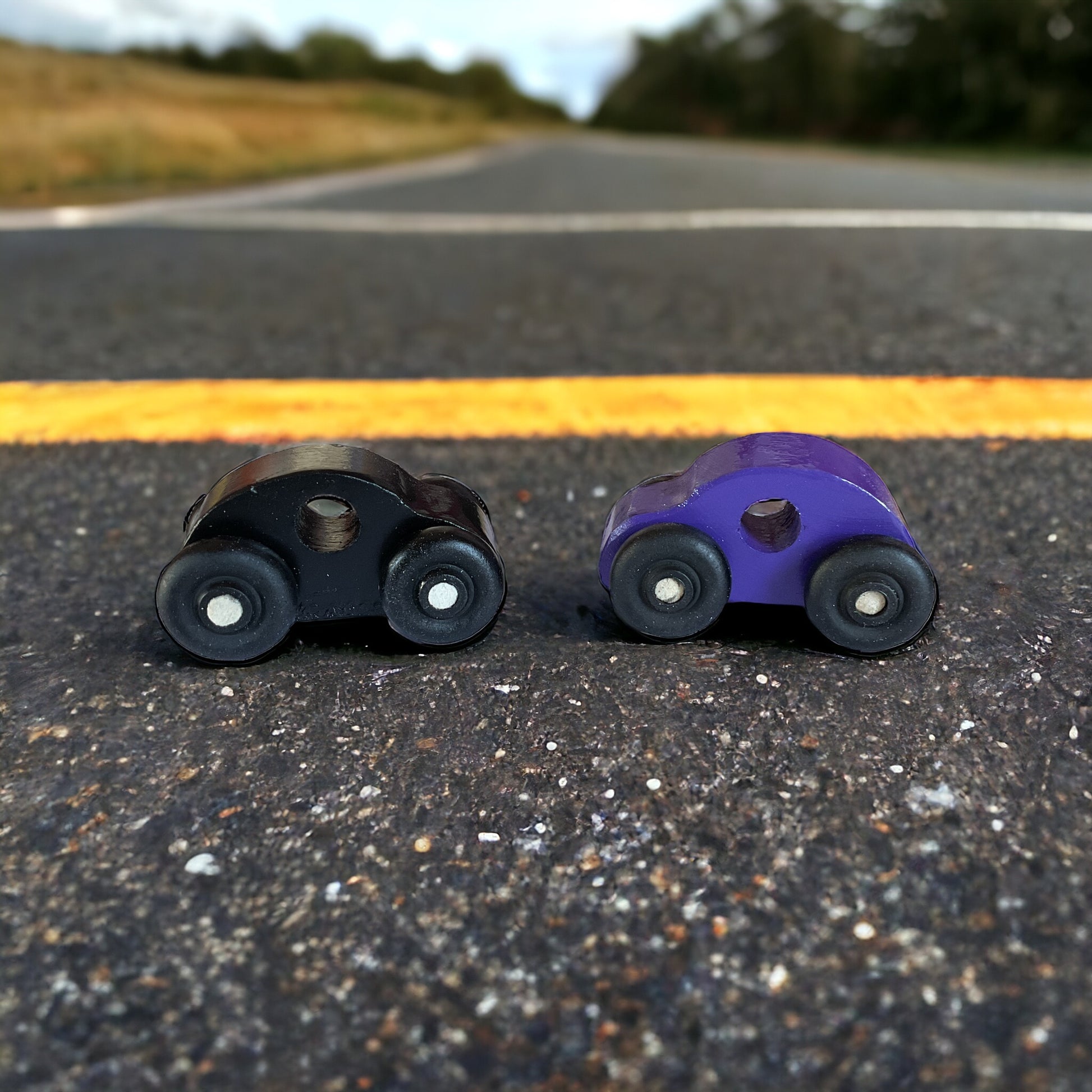 two painted wooded cars on the street