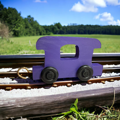 wooden purple train on tracks