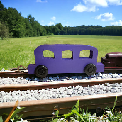 wooden purple train on tracks