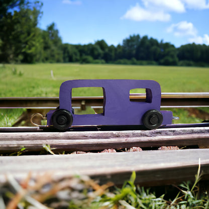 wooden purple train on tracks