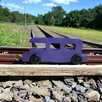 wooden purple train on tracks