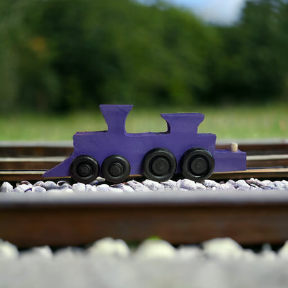 wooden purple train on tracks