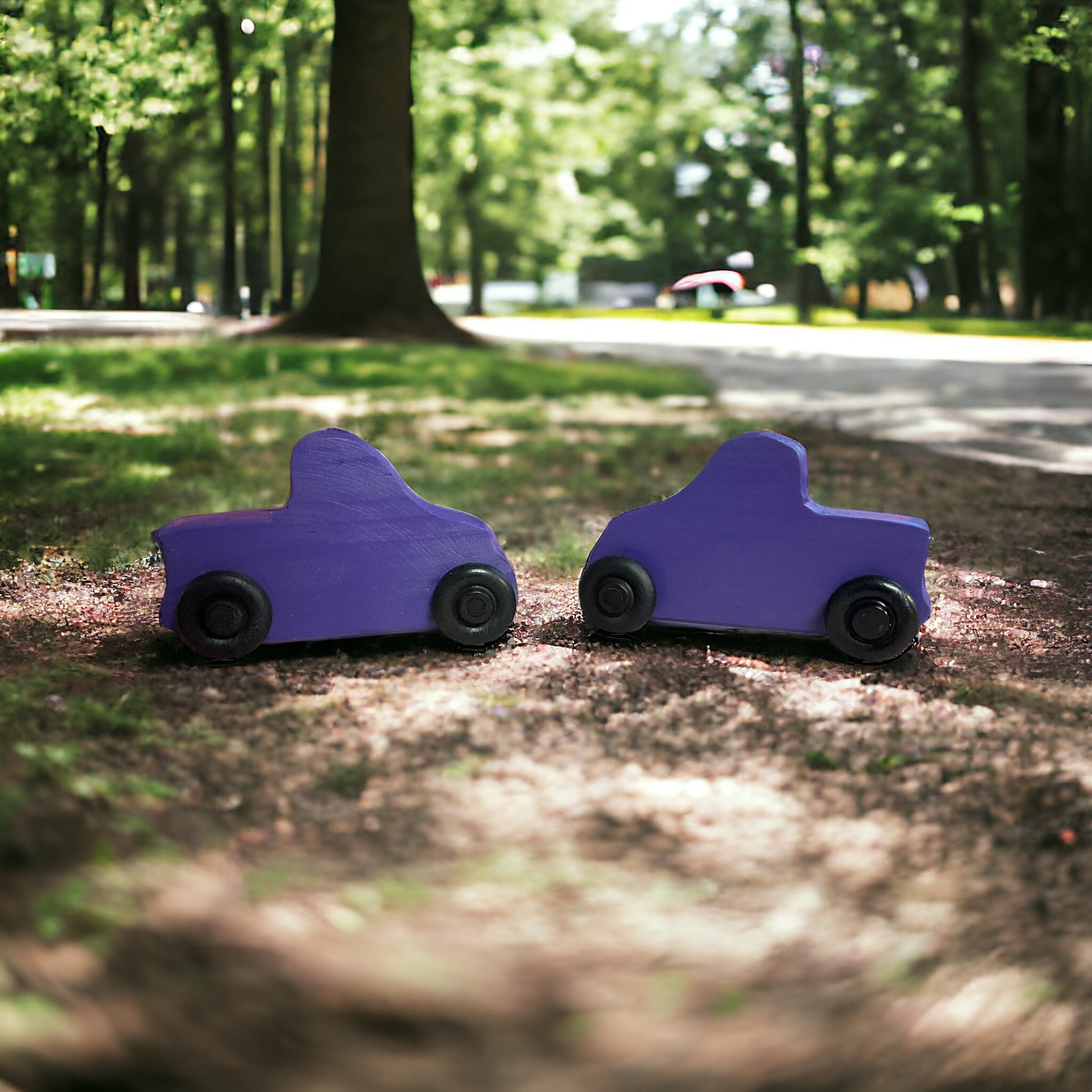 two purple wooden trucks in the park