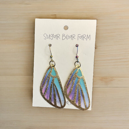 blue butterfly earrings on wood