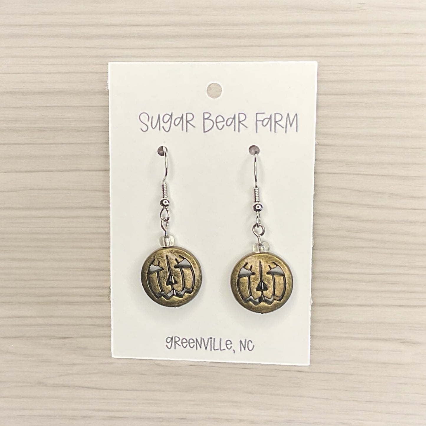 gold colored pumpkin face earrings