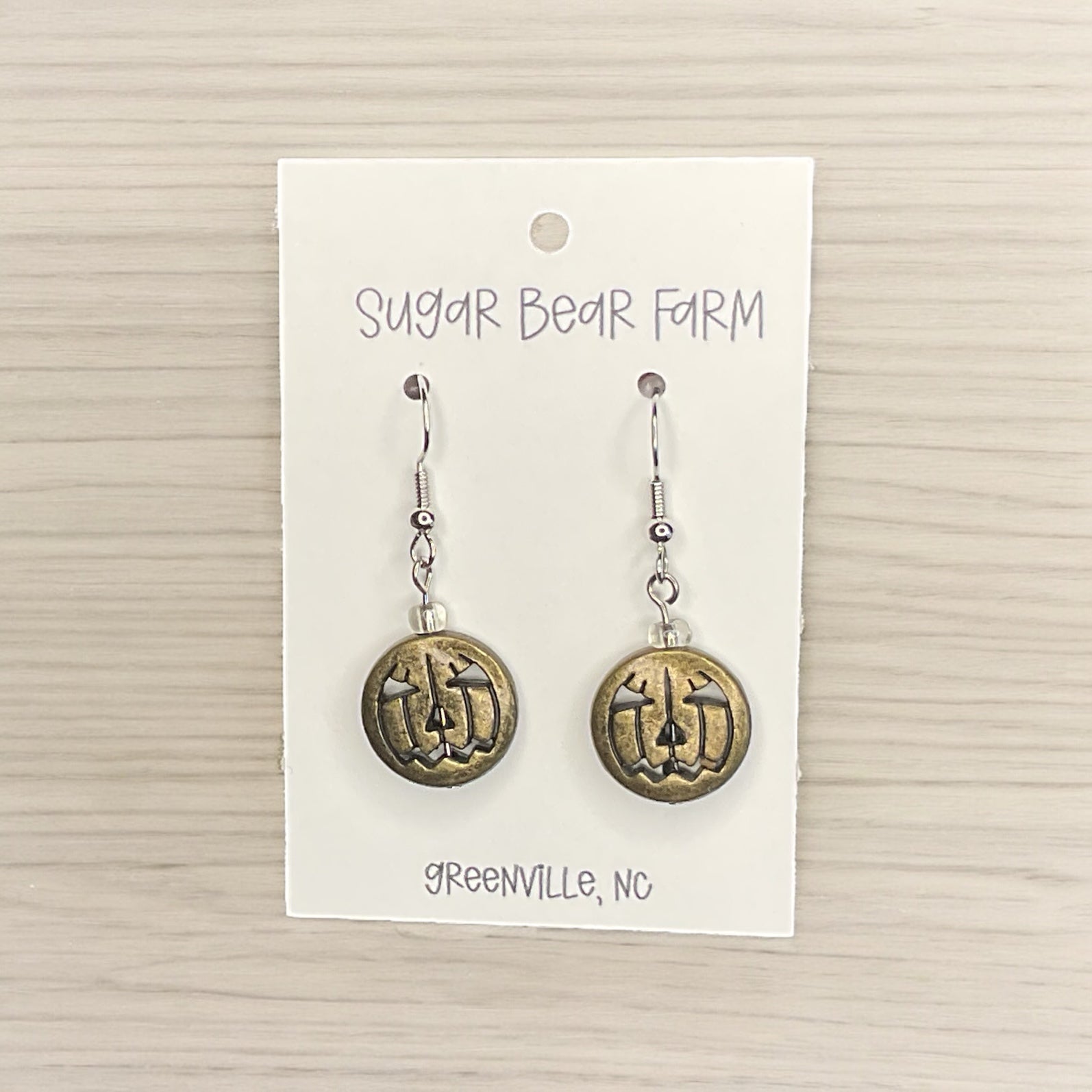 gold colored pumpkin face earrings