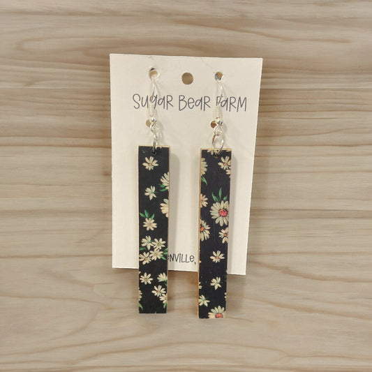 black wooden earrings with daisies