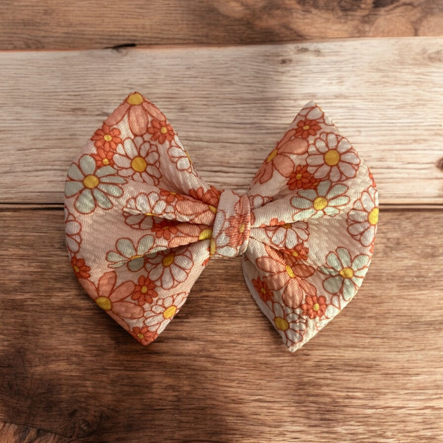 peach flower bow on wooden background