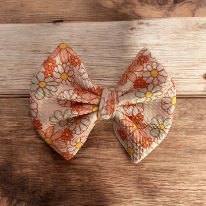 peach flower bow on wooden background