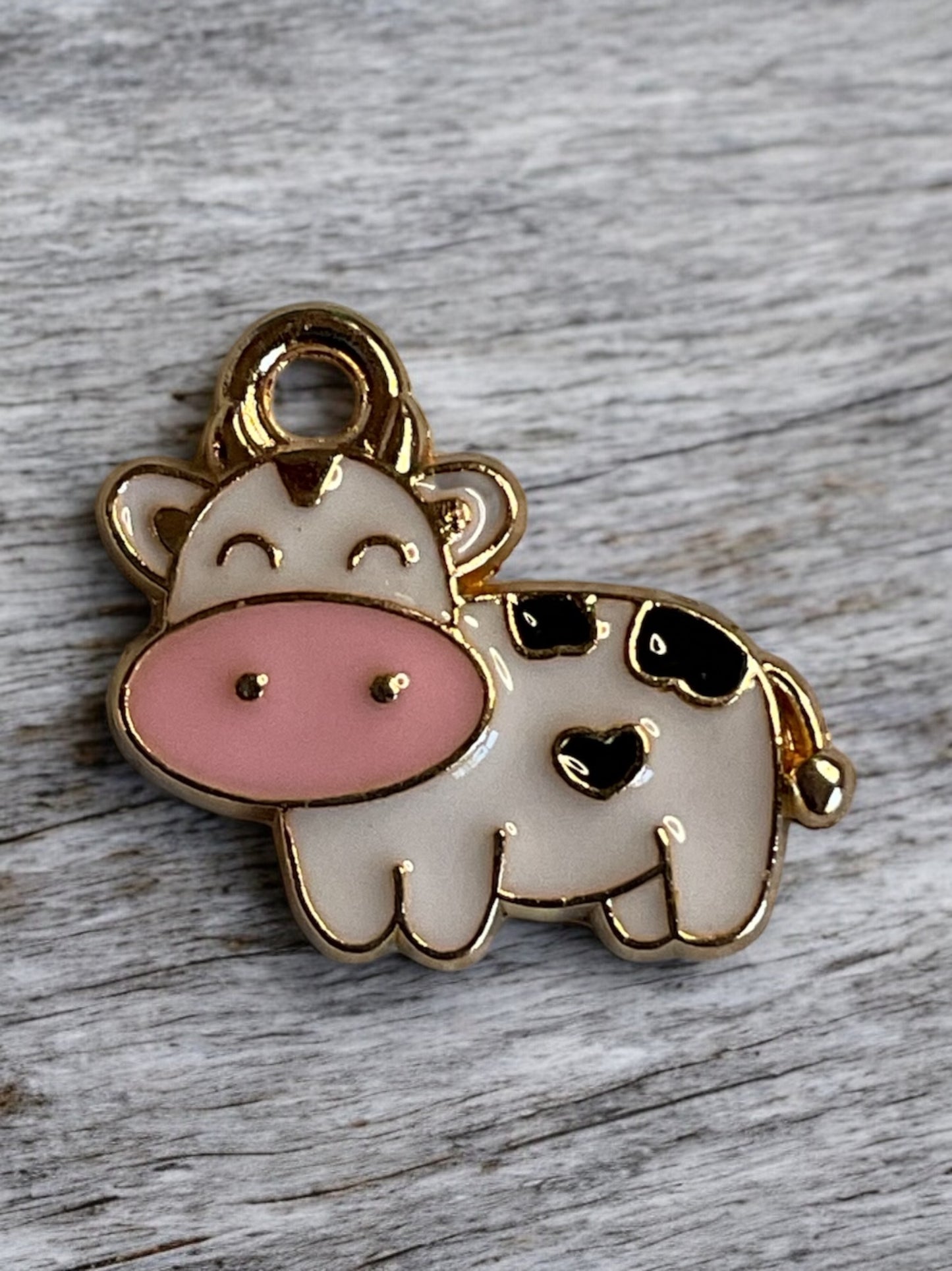 Close up of a white and black cow charm