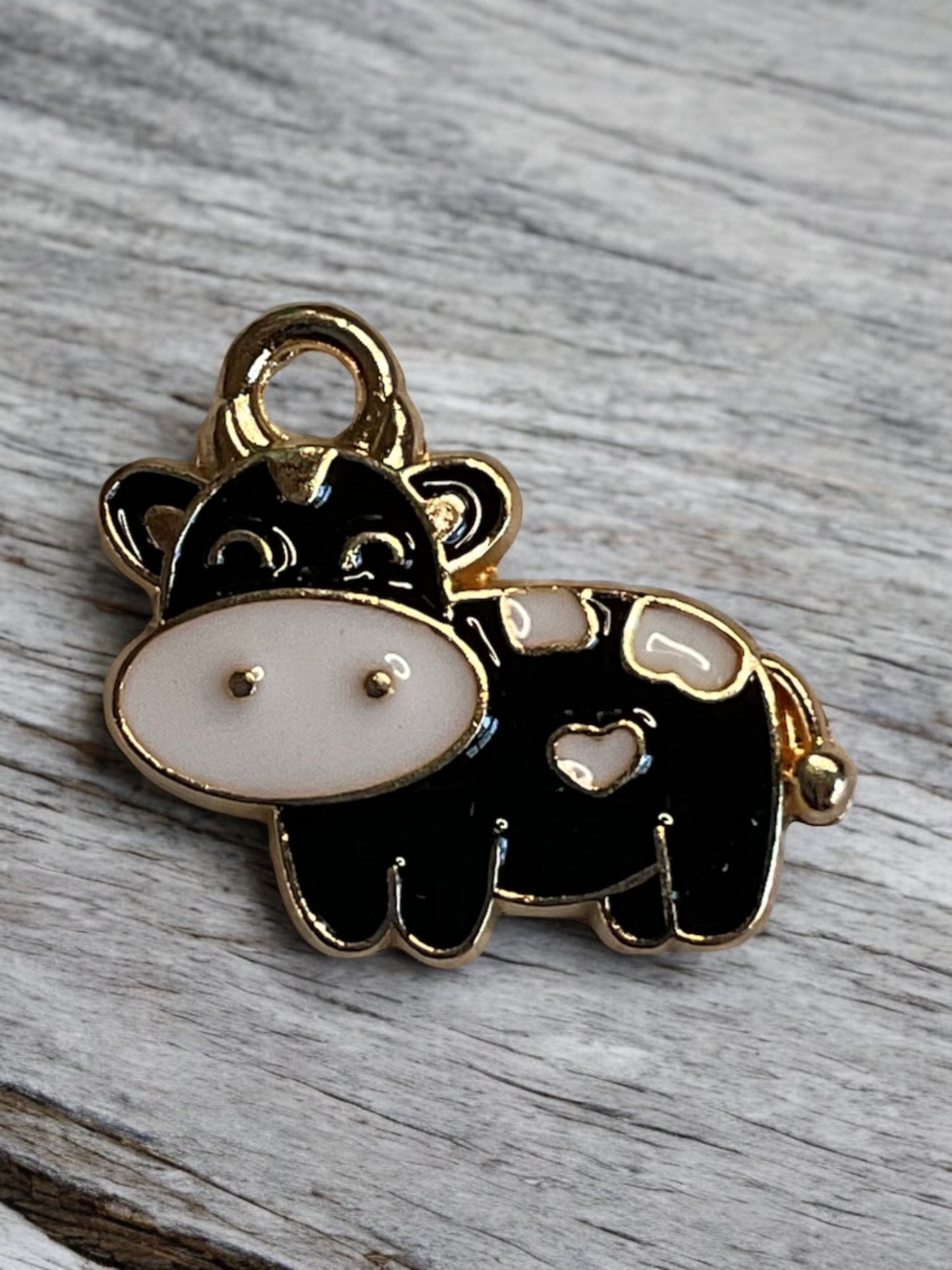 Close up of a black and white cow charm