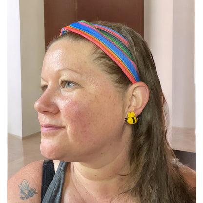 Woman wearing headband and bee earrings