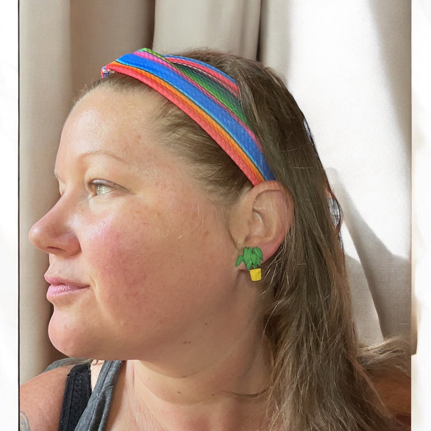 Woman wearing headband and plant earrings